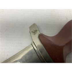 WW2 German SA dagger the 22cm double edged steel blade by G. Felix Gloriawerk Solingen inscribed 'Alles Fur Deutschland', the cross-piece impressed with the SA Gruppen mark Nm verso for Nordmark, wooden grip inset with eagle and SA emblem; in brown painted scabbard with nickel mounts L37cm overall