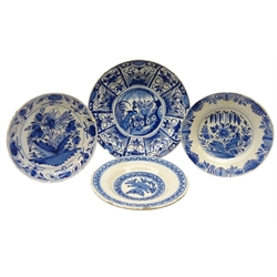  18th century Delft blue and white plate decorated in the Kraak style, the central panel painted with a peacock within a garden, D30cm and three other early Deflt ware plates (4)  