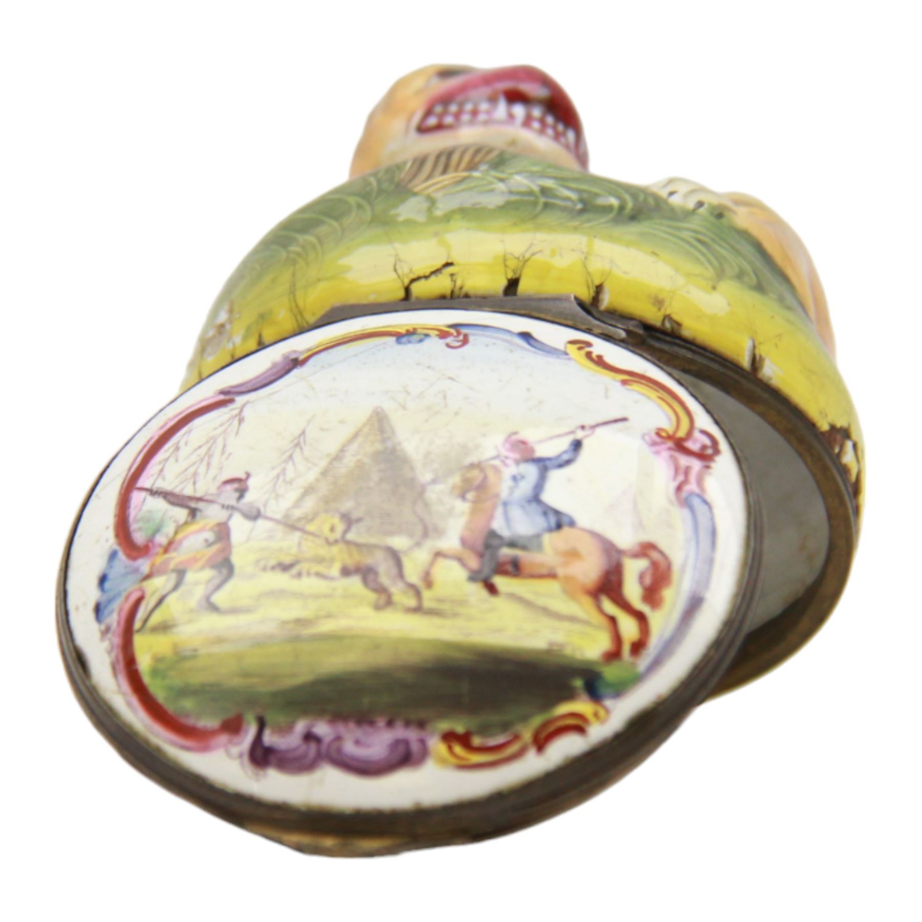 Rare 18th century Birmingham enamel bonbonniere, circa 1760, modelled as a grinning tiger laid upon a grassy sgraffito mound, the base decorated with a lion hunting scene after Antonio Tempesta, within a polychrome scroll surround, H5.5cm D6cm
