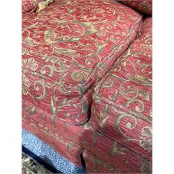 Large Knole design hardwood-framed three-seat drop-arm sofa, upholstered in crimson fabric decorated with trailing acanthus leaves and shields, together with scatter cushions 