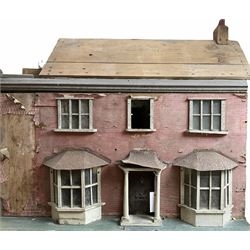 Late 19th/early 20th century pine dolls house for restoration of Victorian two-sided double fronted two-storey form with additional separate two-storey extension, brick paper covered walls with undecorated roof, two bay windows and portico with tin roofs, the single hinged front enclosing central hall, stairs and landing flanked by two rooms to either side, each fitted with a 'cast-iron' fire-place or range, the separate extension with two rooms and roof terrace, main house H85cm W93cm D57cm extension H57cm W41cm D52cm