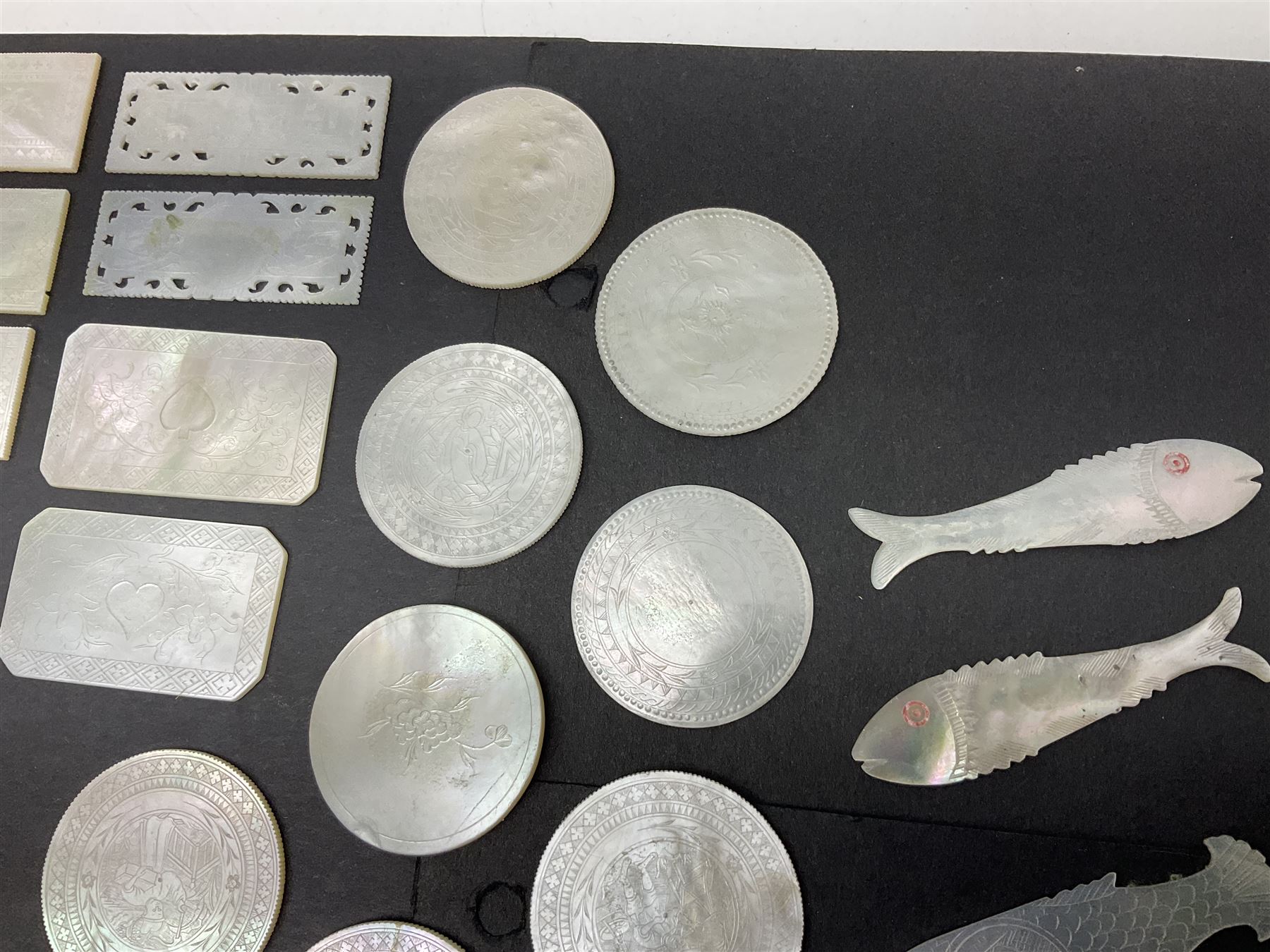 Collection of fifty seven Chinese mother of pearl gaming counters or tokens, of various size and form including rectangular, circular and fish shaped examples, various decoration including floral motifs, largest rectangular examples L6cm
