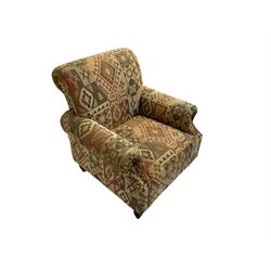 Traditional shaped armchair upholstered in patterned fabric