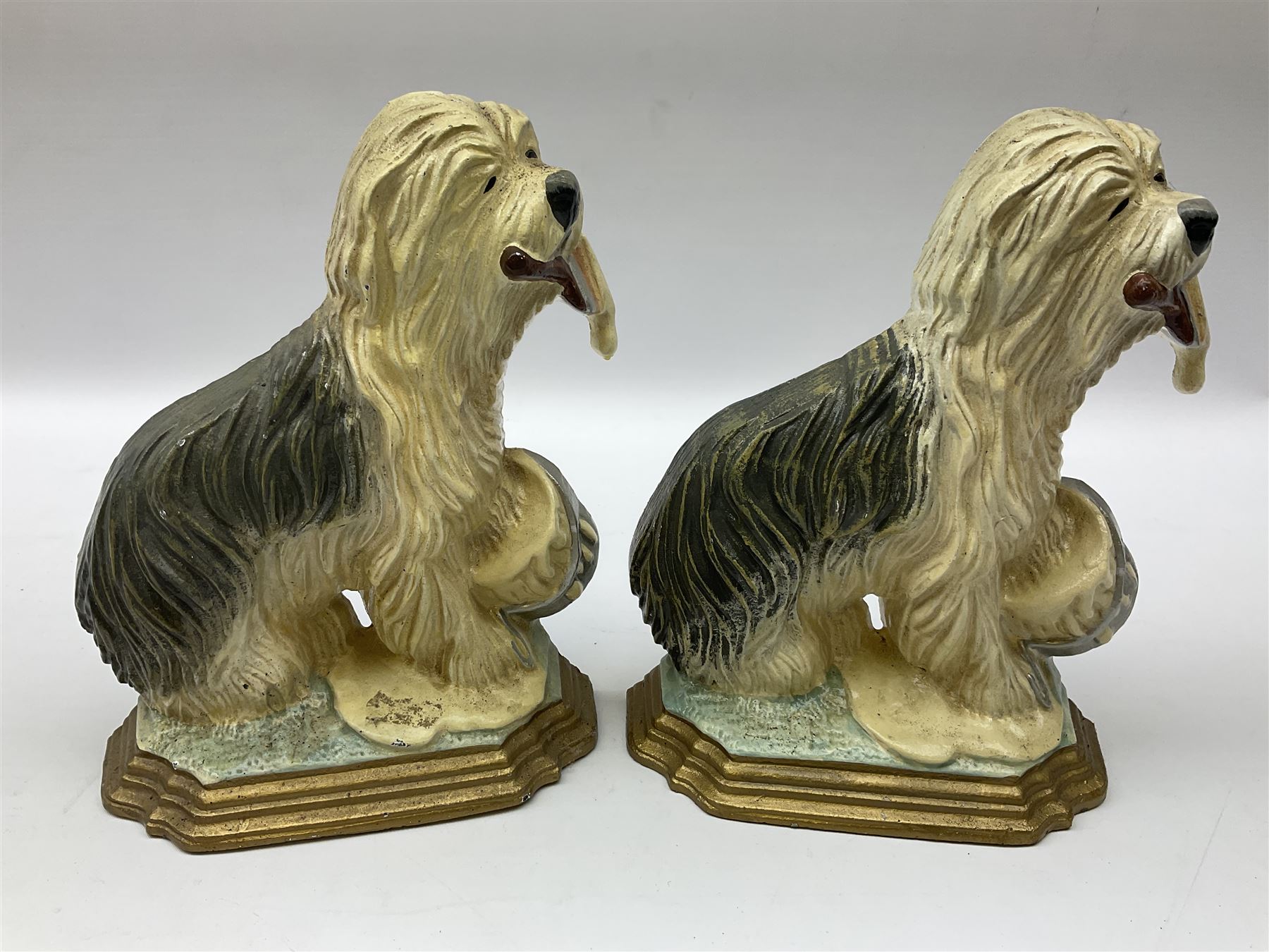 Pair of cast iron Dulux Old English sheepdog doorstops together with another modelled as a golfer