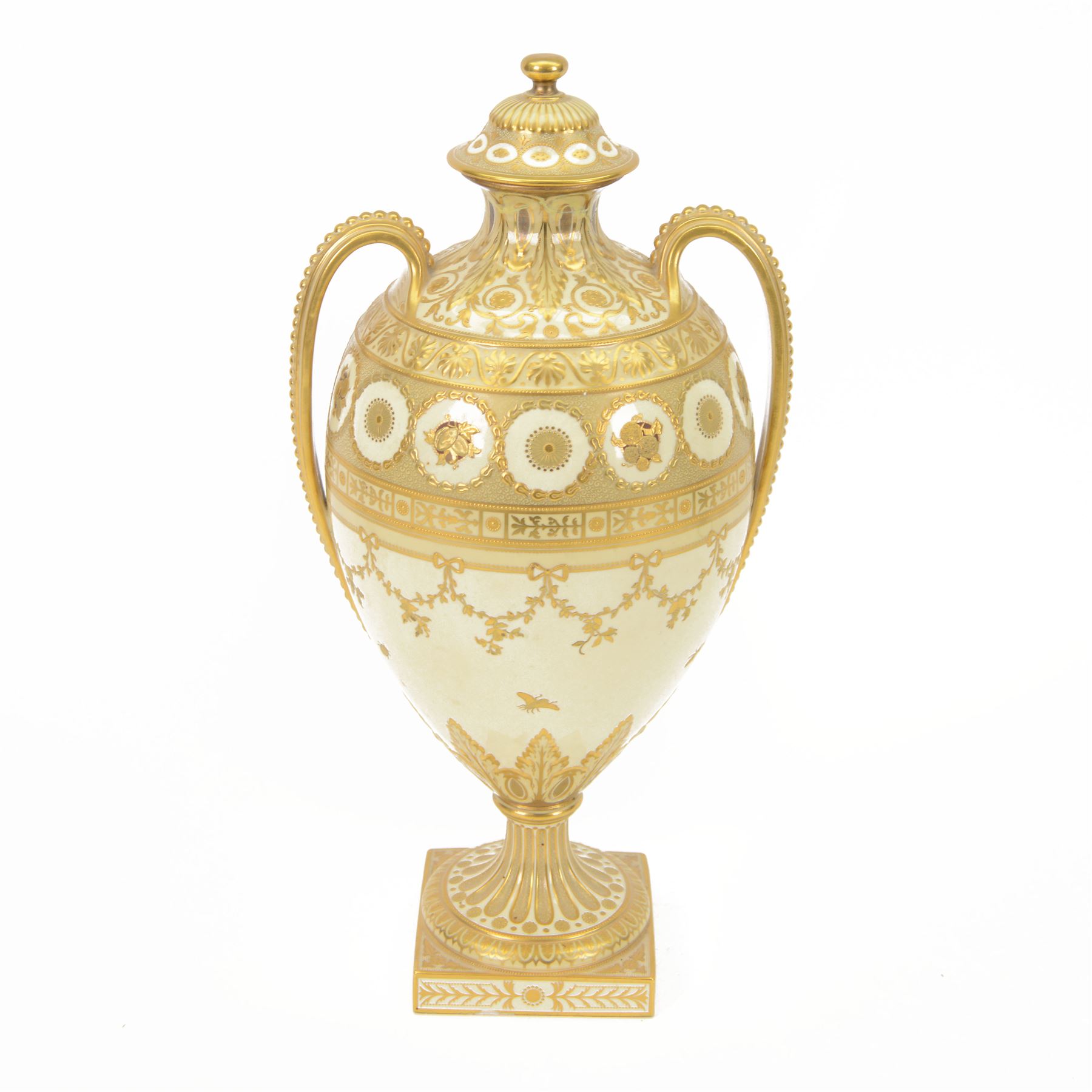 Royal Crown Derby twin handled vase and cover, circa 1886, decorated with raised and tooled gilt borders of foliate scrolls and husk swags upon a cream ground, H38cm