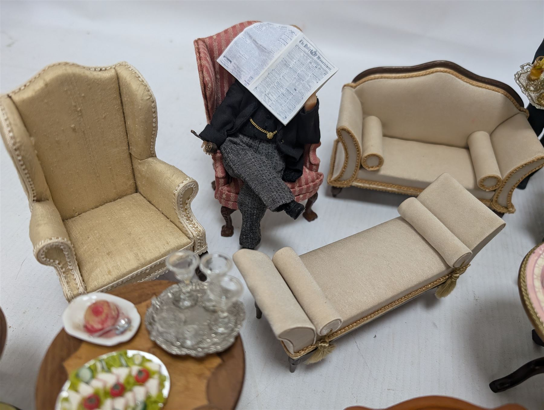 Dolls house furniture, including sofa, chairs, foot stools, fireplace, sideboards, five figures, mirrors, paintings and accessories