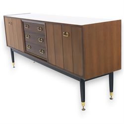G Plan - ‘Librenza’ tola wood sideboard, the rectangular top above two cupboards to either side and three graduated central drawers, the drawer and door fronts veneered in figured tola wood with brass handles, standing on splayed tapering legs