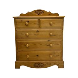 Pine chest of drawers topped with carved pediment with acorn and oak leaf motif, fitted with two short over three long drawers, standing on shaped apron base (W92, D46, H97cm); pine bedside cabinet, single drawer above paneled cupboard door enclosing open storage, shaped plinth base (W43, L32, H67cm)
