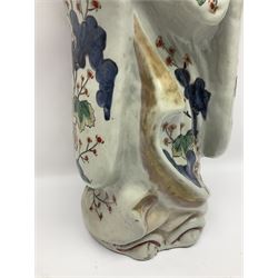 Large Japanese Imari porcelain figure, modelled as a Bijin, wearing a long kimono decorated with apple blossom and leafy branches on a white ground, with gilt detailing, possibly Edo period, H63cm