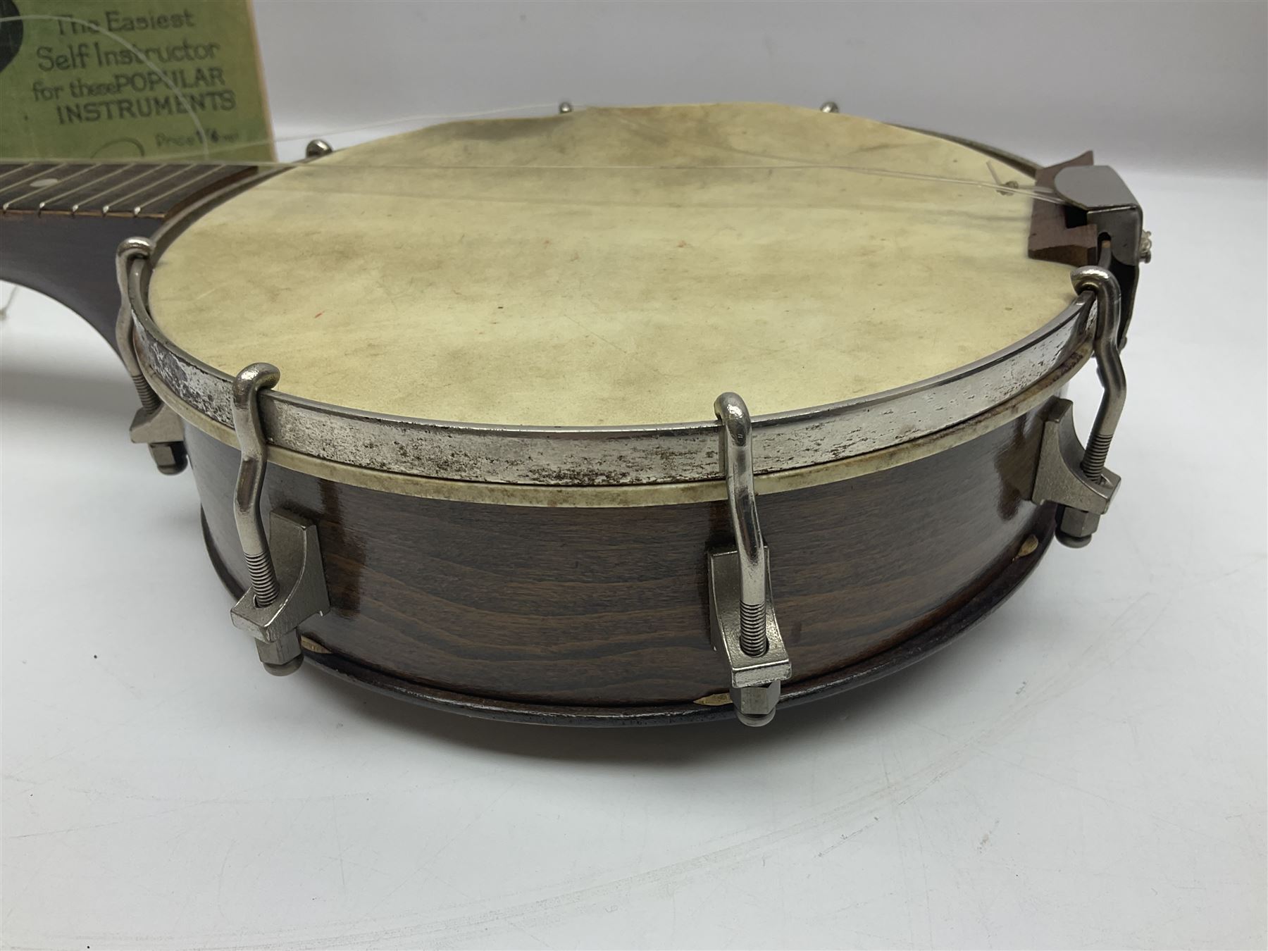 George Formby banjolele with metal plaque to headstock L55cm; in carrying case with instruction booklet.