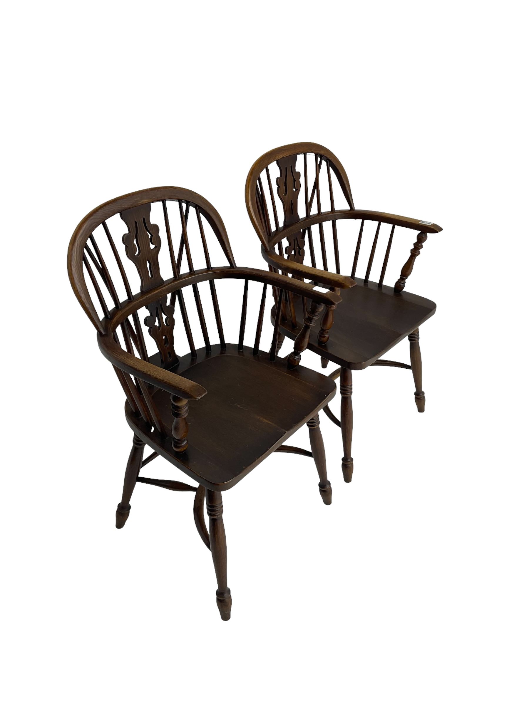 Pair late 20th century oak Windsor elbow chairs, double hoop and stick back with pierced and fretwork work splat, dished seat on turned supports joined by crinoline stretcher