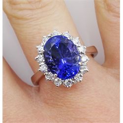 18ct white gold oval tanzanite and round brilliant cut diamond cluster ring, stamped 750, tanzanite approx 4.20 carat, total diamond weight approx 0.45 carat