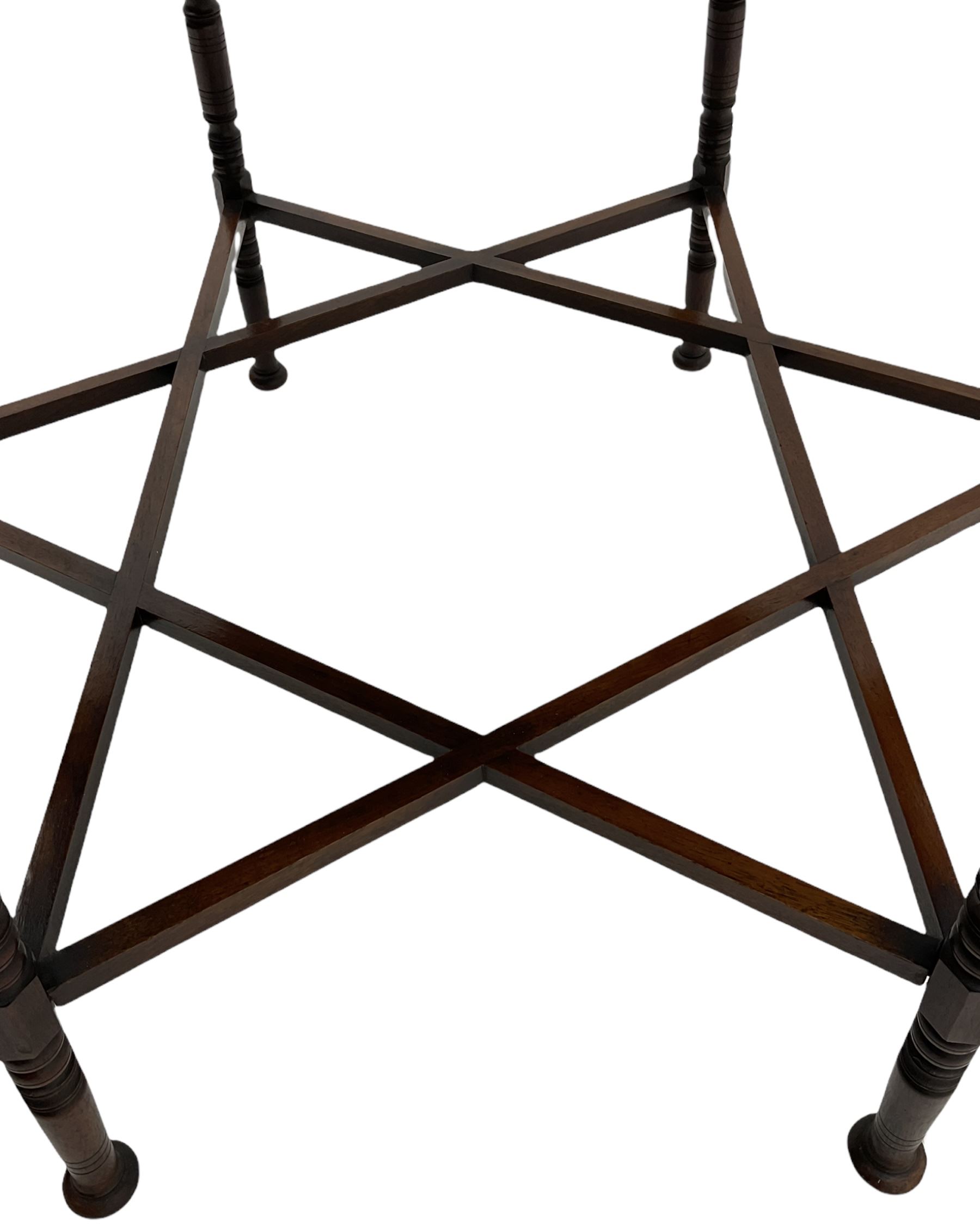 Liberty & Co circa 1890 - walnut centre table, hexagonal form, fretwork frieze, star stretcher base, turned supports on button feet. Stamped on underside.
Featured in - Pictorial Dictionary of British 19th century Furniture Design, Daryl Bennett Liberty's Furniture, 1875-1915, The Birth of Modern Design.
Liberty Style, The Classic Years, 1898 - 1910, by Mervin Levy.