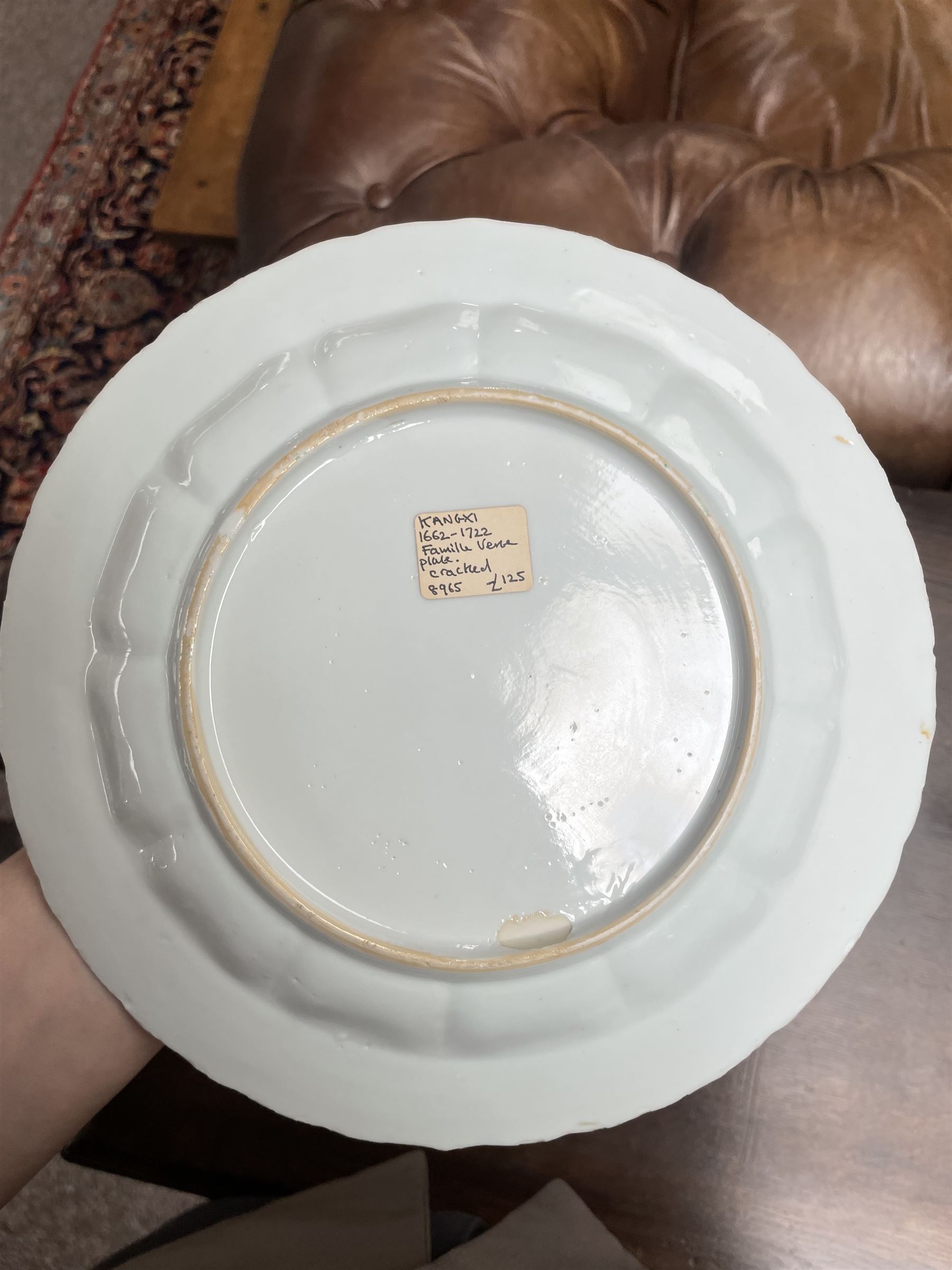 Chinese Kangxi famille verte plate, decorated with a bird perched upon a blossoming branch, within an iron red foliate border, D22cm