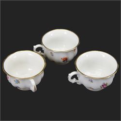 Forstenberg part tea and dinner service, comprising teapot, teacups and saucers, dinner plates, tureens, sauce boat, lidded sugar bowl, side plates and serving plates, all decorated with polychrome floral sprigs on a white ground with gilt edging