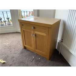 Light oak two door side cabinet- LOT SUBJECT TO VAT ON THE HAMMER PRICE - To be collected by appointment from The Ambassador Hotel, 36-38 Esplanade, Scarborough YO11 2AY. ALL GOODS MUST BE REMOVED BY WEDNESDAY 15TH JUNE.