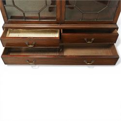 Early 20th century mahogany glazed bookcase, the moulded cornice above a carved frieze with interlaced ornament, enclosed by a pair of astragal glazed doors with geometric glazing bars, the base fitted with two short over two long drawers with brass swan neck handles, raised on bracket feet