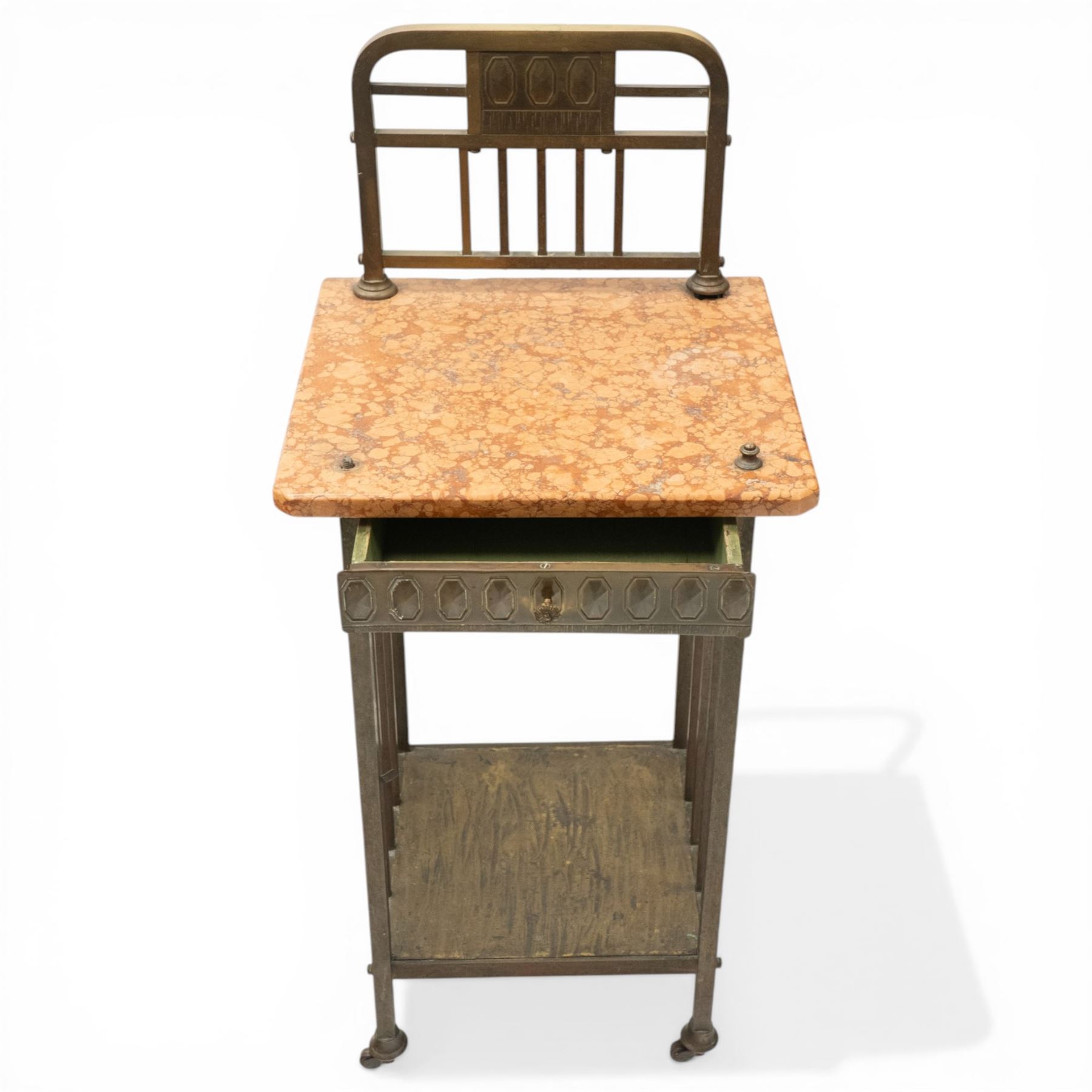 Pair of European Art Deco brass and marble bedside tables, the raised bass back over a canted rectangular marble top, fitted with single drawer decorated with repeating octagonal decoration, raised on square tubular supports with castors, united by undertier