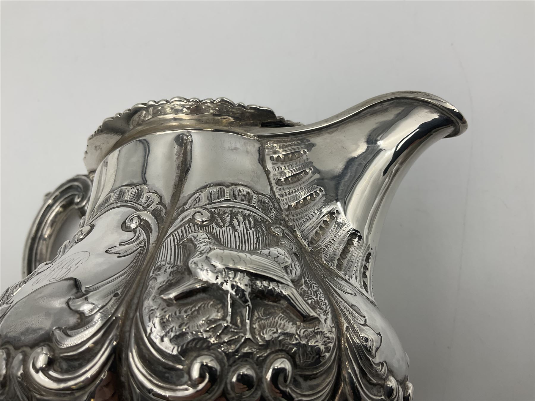 Victorian silver three piece tea service, comprising teapot, twin handled open sucrier, and milk jug, each of bellied form with acanthus capped scroll handles, the sides embossed with alternating scroll edged vacant panels and panels containing a pair of birds, upon four palmette feet, the teapot with ivory insulators to handle, and bird finial to the hinged domed cover, hallmarked William Hunter & Son, London 1861, teapot H19cm, including handles sucrier H13.5cm, including handle milk jug H12cm

This item has been registered for sale under Section 10 of the APHA Ivory Act