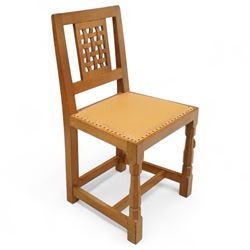 Mouseman - set of six oak dining chairs (5 + 1), pierced and carved lattice back over leather upholstered seat, on octagonal front supports united by stretchers, carved with mouse signature, by the workshop of Robert Thompson, Kilburn