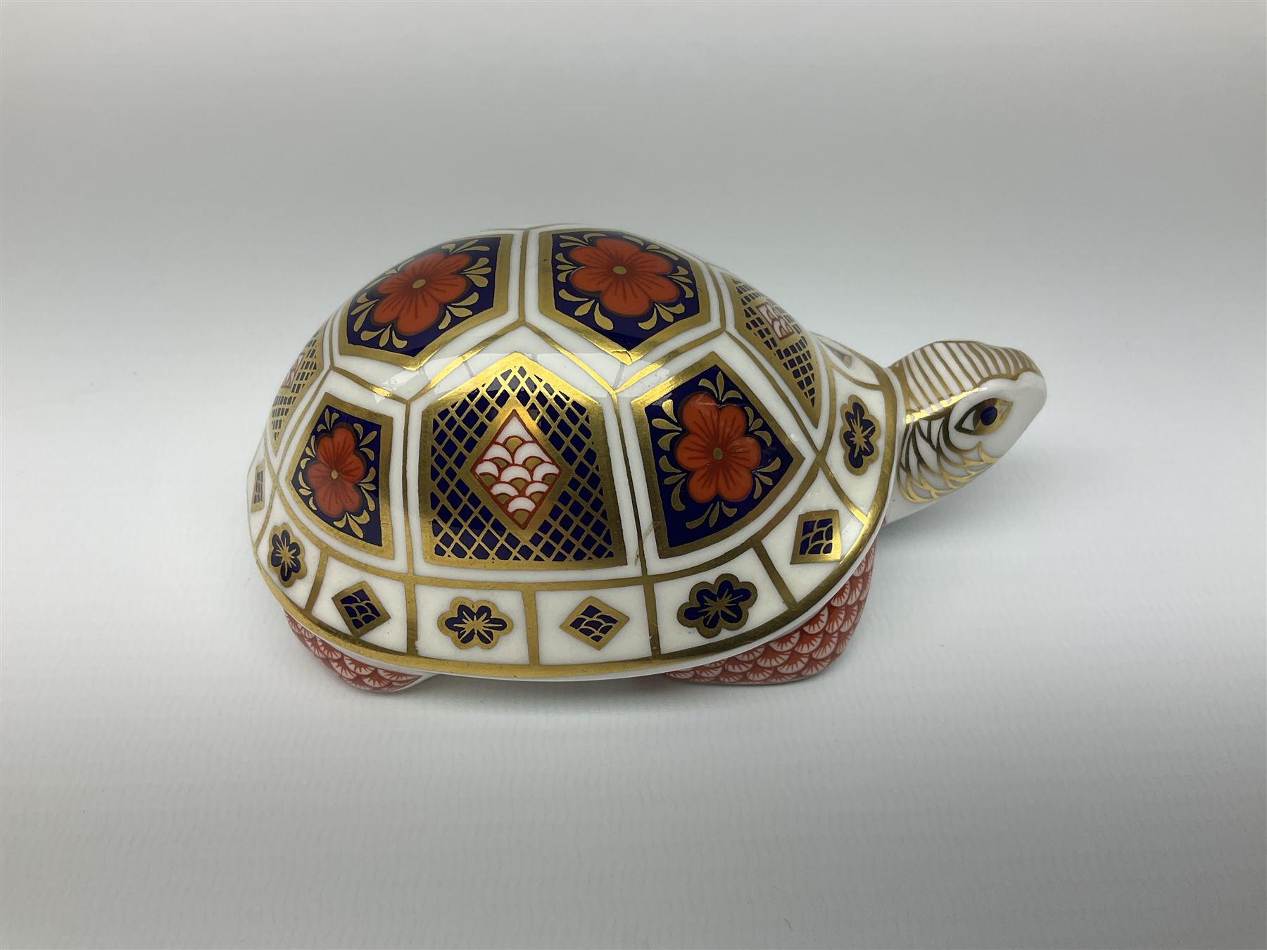 Royal Crown Derby tropical fish paperweight in the form of a Guppy, with a silver stopper, and Royal Crown Derby tortoise paperweight with gold stopper