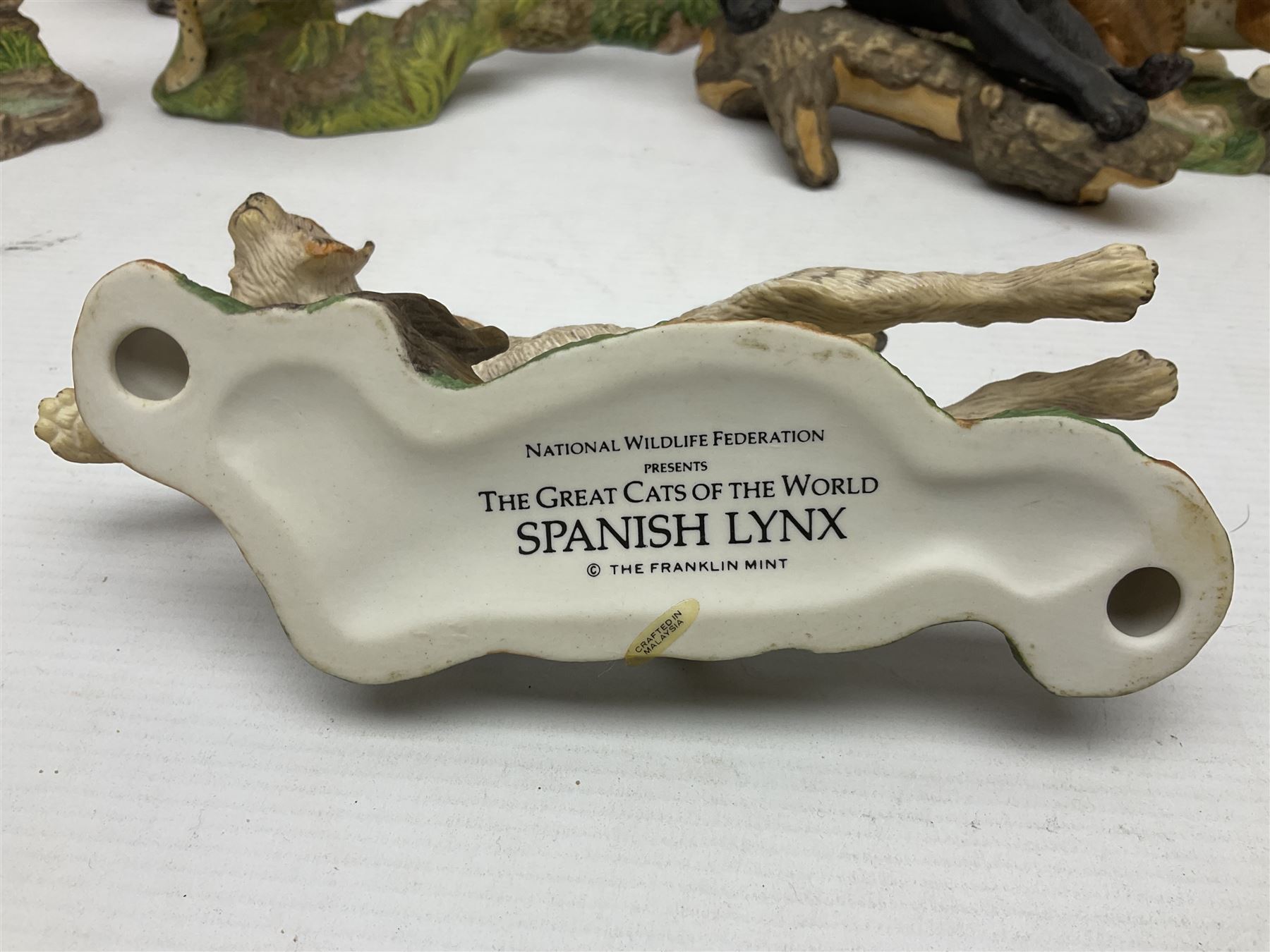 Ten Franklin Mint National wildlife Foundation Big Cats of the World figures to include, White Bengal Tiger, Jaguar, Cougar, Cheetah, Clouded Leopard etc, with display stand