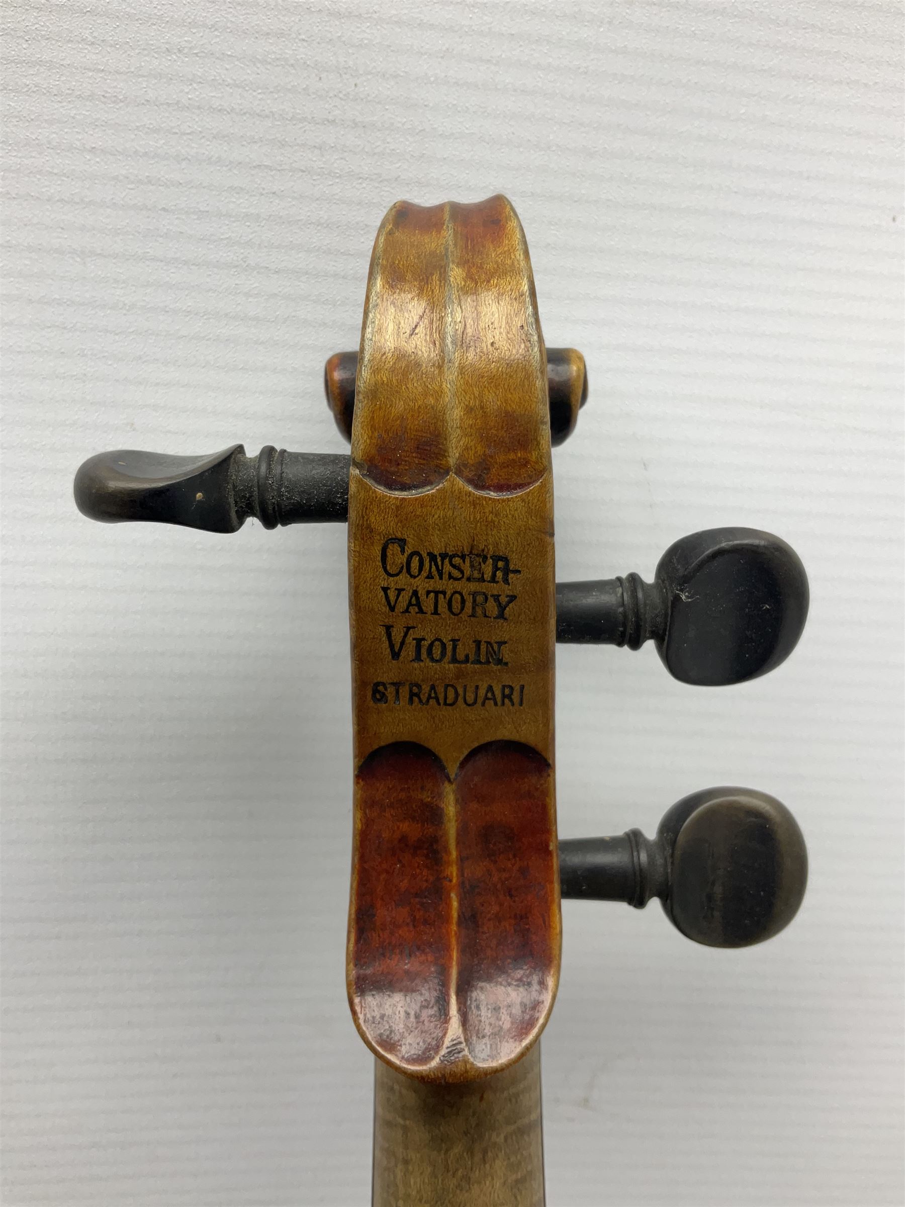 Late 19th century French three-quarter size 'Conservatory' violin with 34cm two-piece maple back and ribs and spruce top, the peg box inscribed 'Conservatory Violin Straduari', bears label 'Antonius Stradiuarius Cremonensis Faciebat Anno 1721' L55.5cm overall; in ebonised wooden 'coffin' case