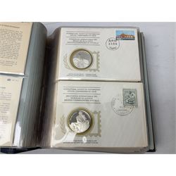 Thirty-six 'International Society of Postmasters Official Commemorative Issues' sterling silver proof medallic covers dating from 1975 to1977, housed in the official folder