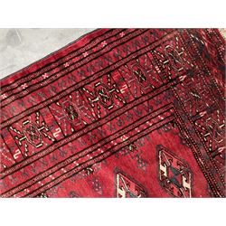 Turkman Bokhara rug, red ground field decorated with repeating Gul motifs