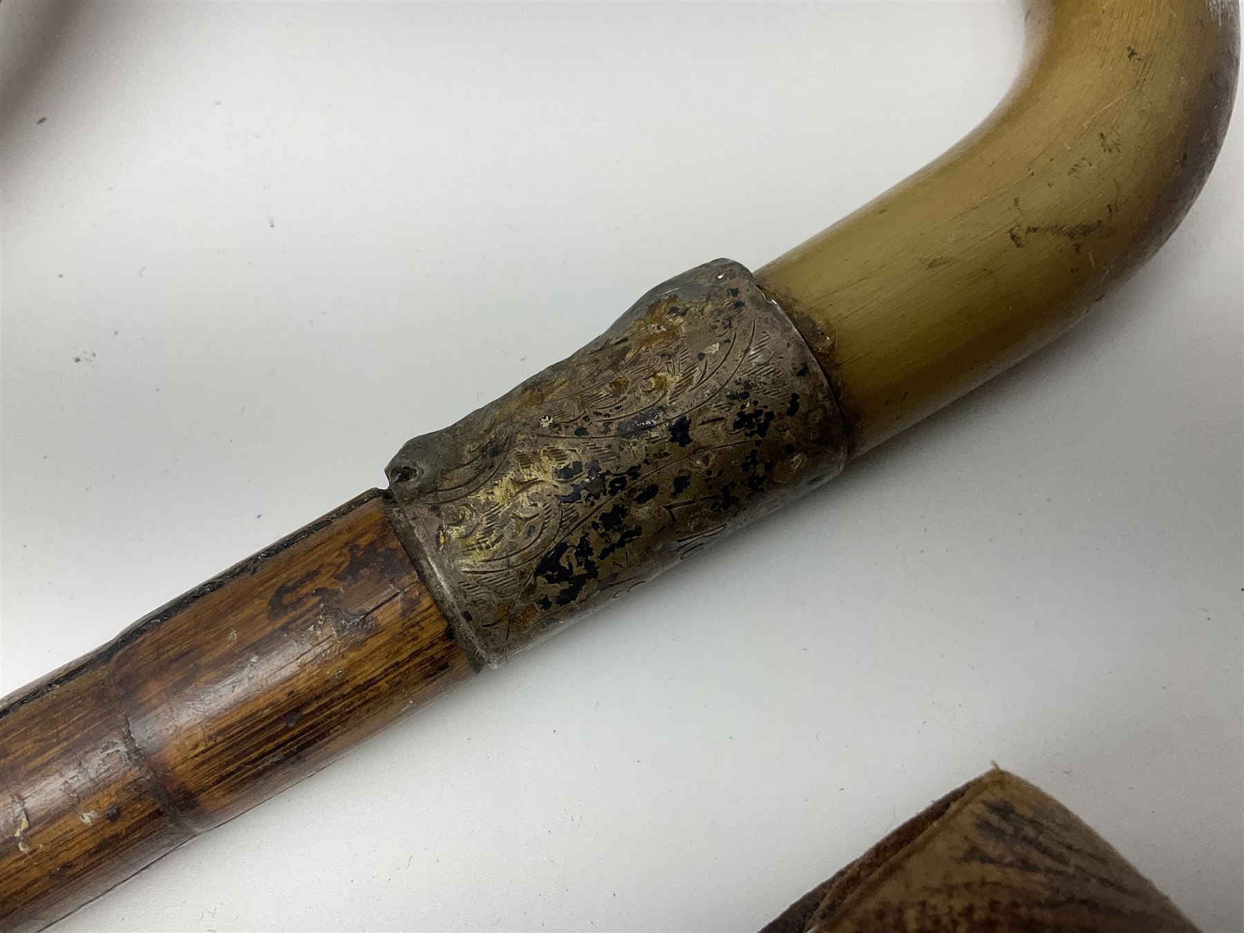 Early 20th century curved horn handle walking stick with hallmarked silver mounts, engraved L Russell 1918, together with a shooting stick by William Mills Birmingham, with leather handle, 'The Featherwaite' shooting stick and an umbrella with wooden handle