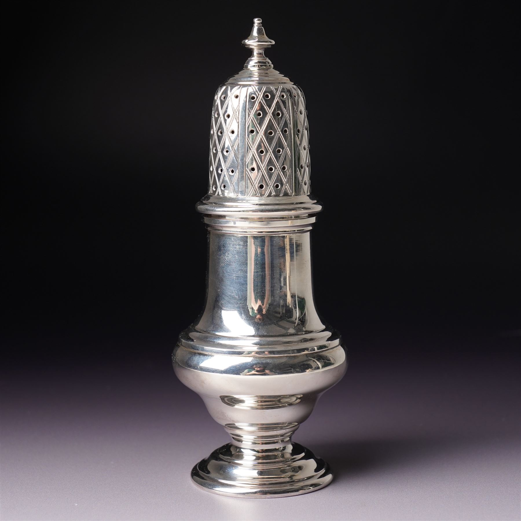 Silver vase shape sugar caster H15cm London 1975 Maker C J Vander Ltd and a George III silver sauce boat with crimped rim and 'C' scroll handle London 1763 Maker possibly William Skeen
