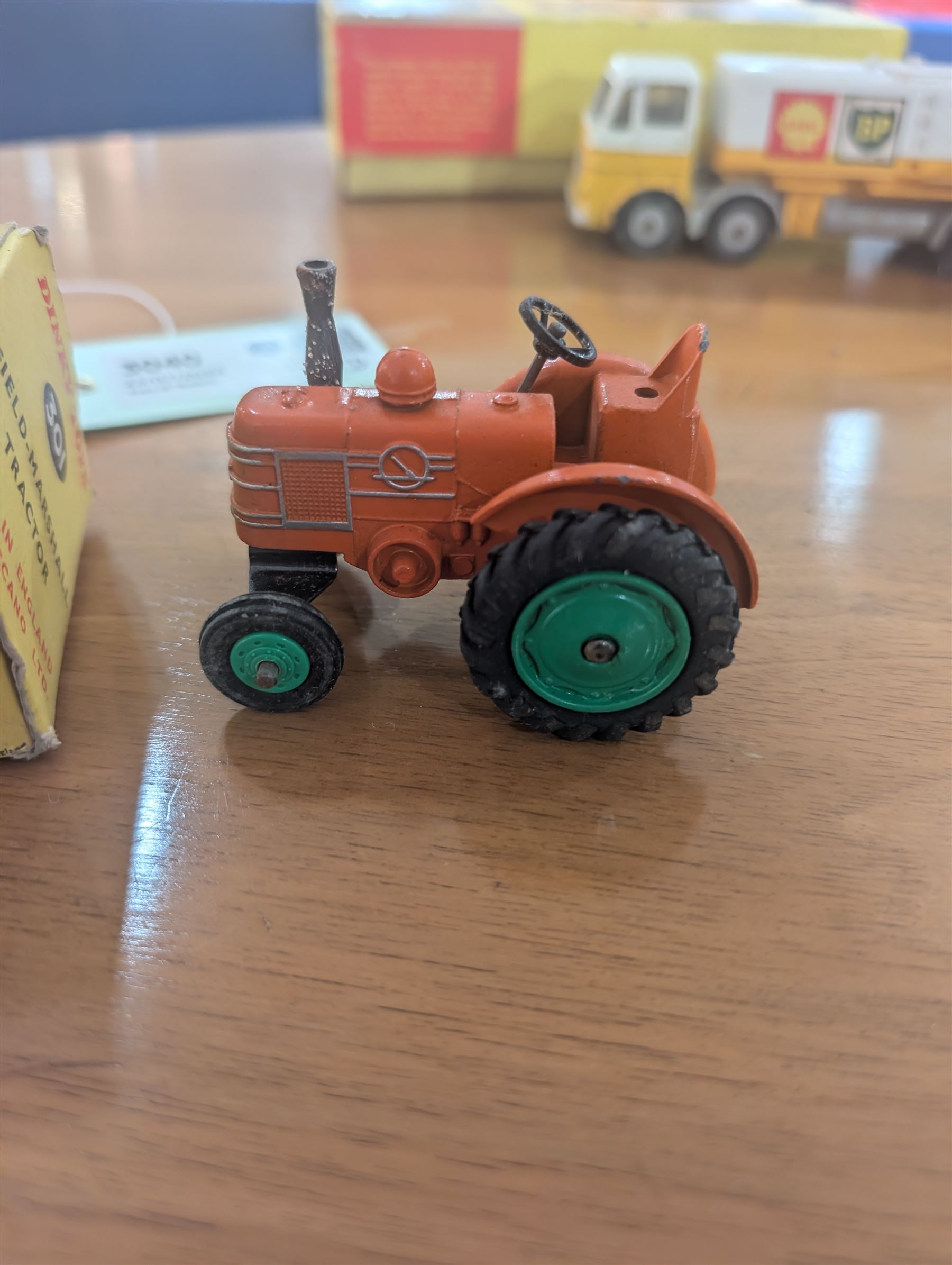 Three Dinky Toys diecast vehicles, comprising Field Marshall Tractor no. 301, Shell BP Fuel Tanker no. 944 and Snow Plough no. 958, all boxed