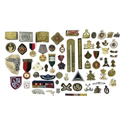 Collection of approximately sixty worldwide medals, metal badges, belt buckles, cloth badges, trench art, brass button stick etc