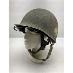 American first type paratrooper helmet with post-WW2 strap and D-rings and later 1944 liner bearing Firestone Tyre and Rubber Company mark; green textured finish