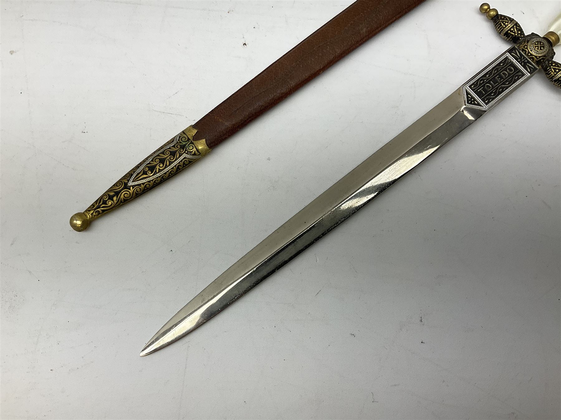 Malayan Kris dagger, the 31.5cm double edged straight heavy damascus blade with copper ferrule; carved hardwood grip; in large wooden throated scabbard with floral decorated white metal covering L47.5cm overall; a kris blade with adapted antler grip; and five various small daggers/letter openers (7)