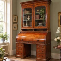 Victorian mahogany cylinder roll-top bookcase-secretaire, projecting cornice over twin gla...