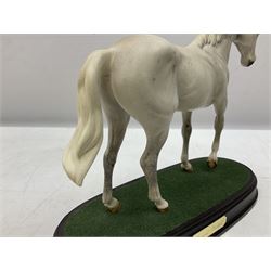 Three Beswick horse figures, comprising large racehorse in bay no. 1564, Desert Orchid on wooden plinth no. DA184and Red Rum on a wooden plinth no. A226, all with printed mark beneath 