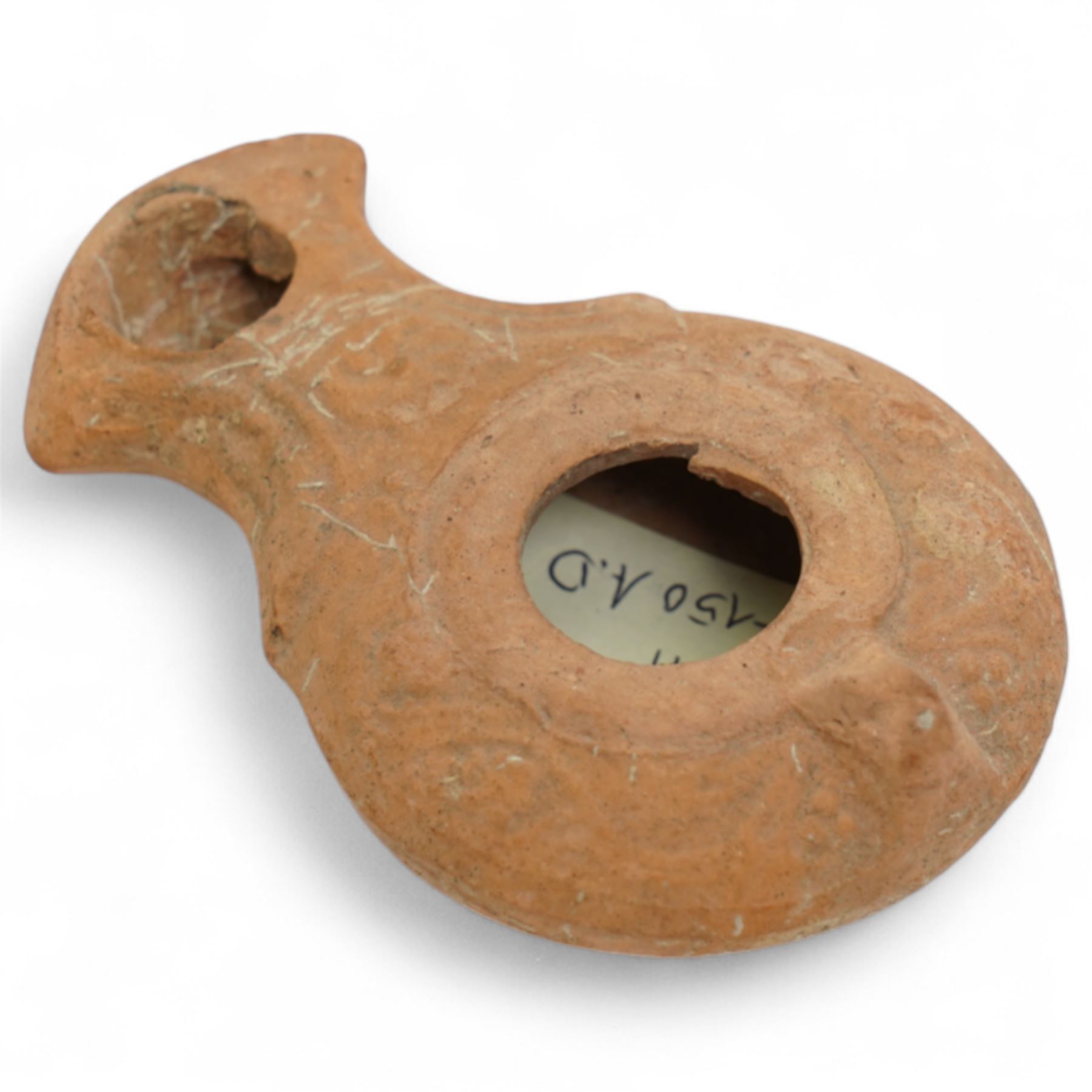 A group of five ancient terracotta oil lamps - Near East and Eastern Mediterranean (c.3rd millennium BC-9th century AD) comprising: Levantine open bowl-type lamp (c.3rd-2nd millennium BC) hand-formed with pinched spout and rounded profile; Near Eastern pinched-spout lamp (c.1200 BC) of coarse red clay with wide central fill hole; Roman oil lamp (c.1st-2nd century AD) with flared spout and a rosette-stamped base; Roman circular oil lamp (c.2nd-3rd century AD) with deeply moulded floral decoration in high relief around the fill hole; and a larger Early Islamic (Arab) lamp (c.7th-9th century AD) decorated with incised geometric motifs to the upper surface
Provenance: By the vendor’s repute, acquired/collected in the Middle East (Dead Sea area/Syria) in the 1960s