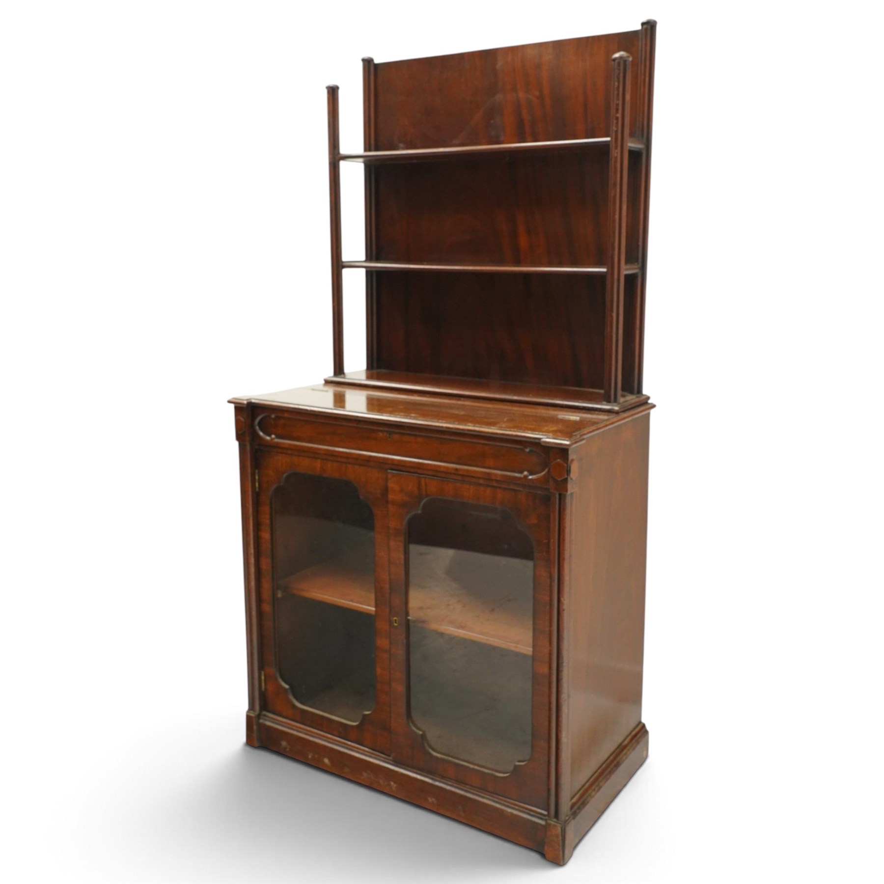 Late 19th century Gothic Inspired secretaire-chiffonier, the raised superstructure with two open shelves and cluster-column uprights, the base fitted with hinged top over secretaire drawer with hinged slope writing surface and pen-rest compartments, over a twin glazed doors enclosing single shelf, the flanking cluster-columns on skirted base