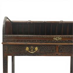 Late 18th century George III mahogany Chippendale design cylindrical roll-top desk carved profusely with geometric and foliate blind-fretwork throughout, the tambour-roll top opening to reveal pigeon holes over an inset red leather writing surface, fitted with two frieze drawers below, raised on square supports with inner chamfer terminating to brass castors, circa 1780s