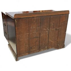 Early 20th century mahogany chest, rectangular top with raised gallery back with brushing slide on sliding tray, fitted with two cupboard doors behind six false drawer fronts, pierced brass handles on a plinth base