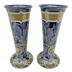 Pair of Doulton Lambeth vases by Emily Stoner, of squat form with flared cylindrical neck, with moulded foliate and bead decoration, H25cm