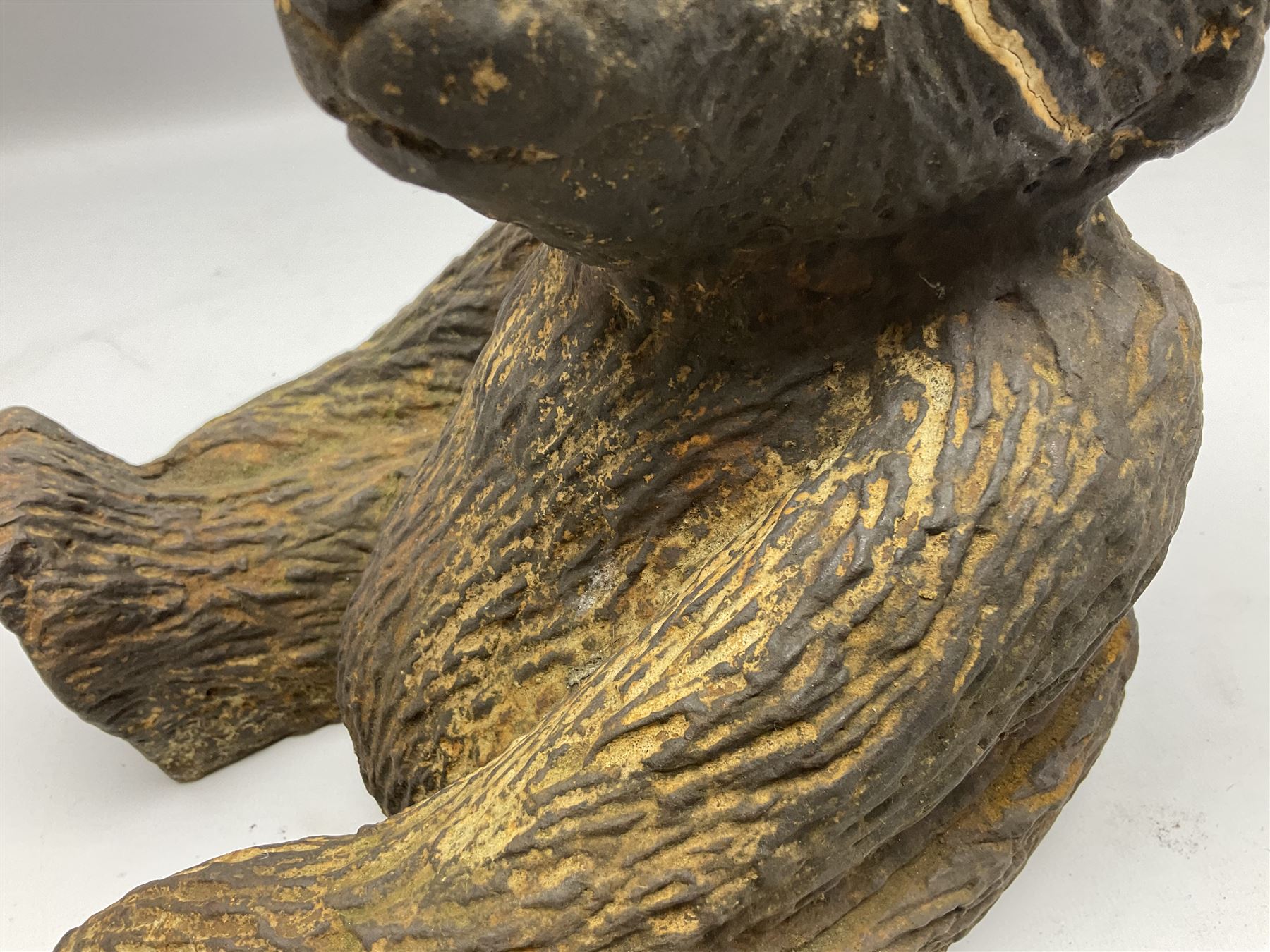 19th century cast iron door stop, modelled as a seated toy bear, with remnants of painted finish, H22.5cm