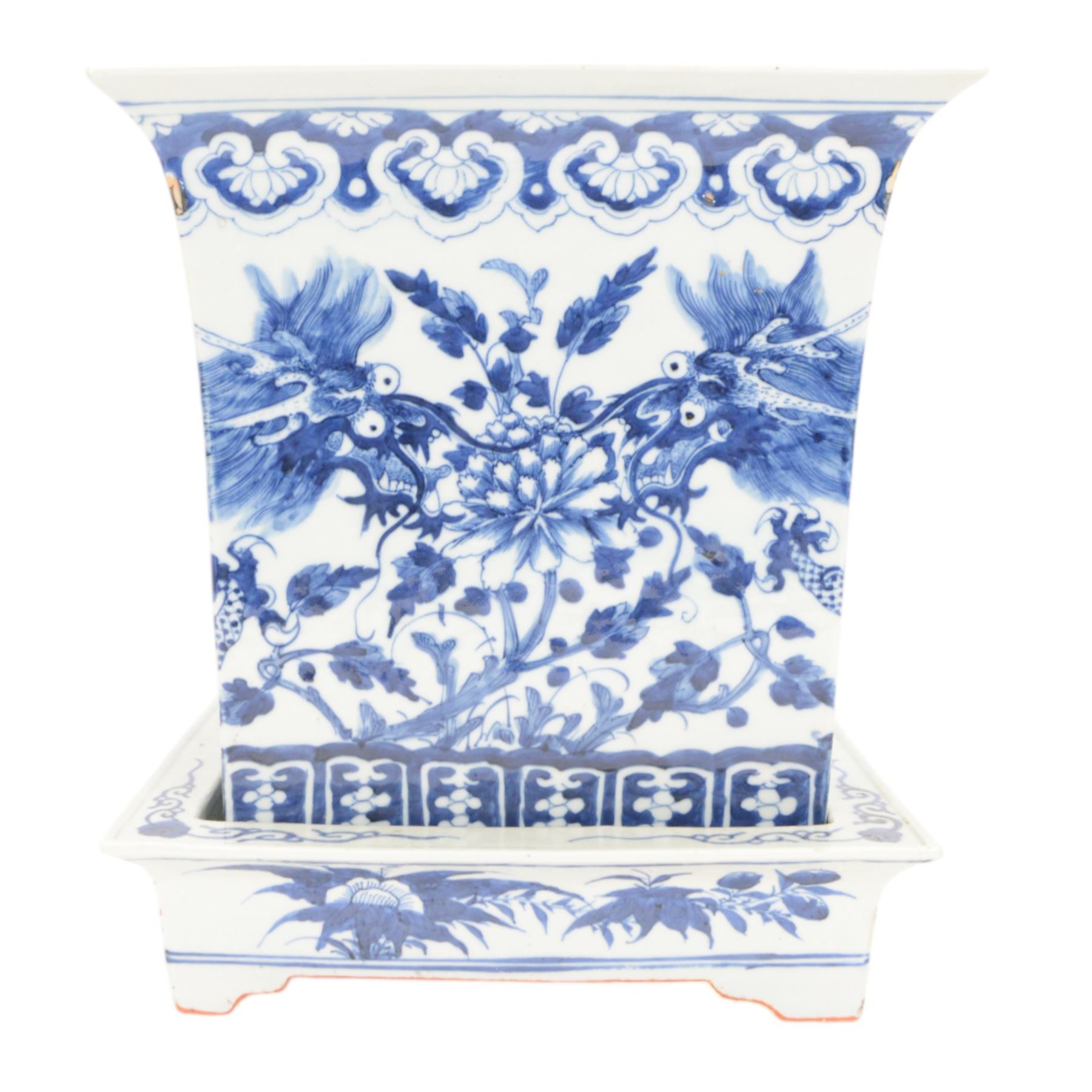 Chinese blue and white planter and stand, each of square slightly tapering and flared form, the planter decorated with two dragons and blossoming peonies, between stylised borders, the stand decorated with flower heads and vines, planter H30cm W29cm, stand H7cm D28.5cm