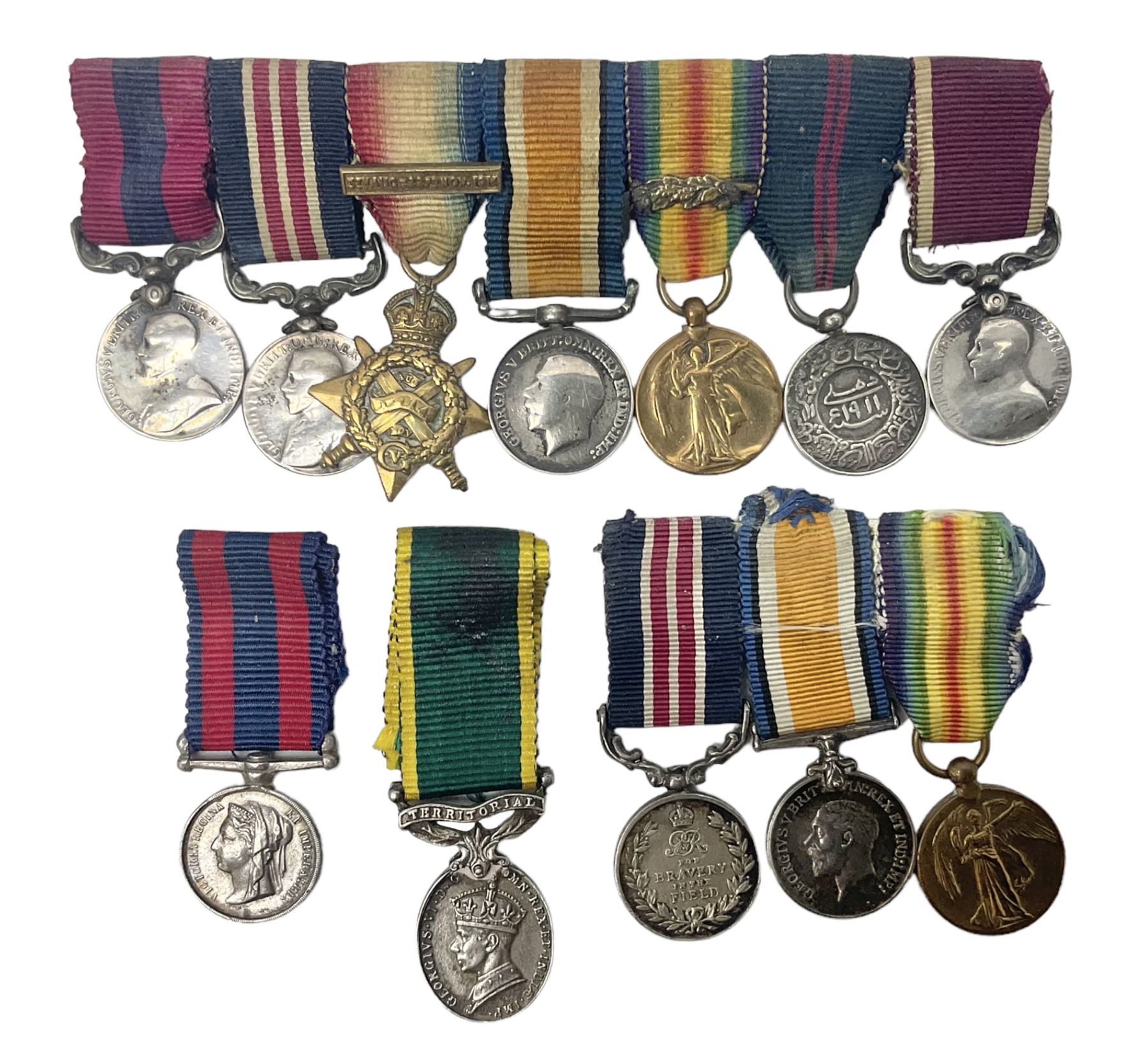 George V Military Medal and Distinguished Conduct Medal miniature group of seven medals comprising MM, DCM, WW1 trio including 1914 Star with date clasp and MID leaves, The Great Durbar Delhi 1911 Medal and LSGC; on pinned wearing bar; WW1 Military Medal miniature group of three comprising MM, BWM and Victory; Victoria North West Canada 1885 miniature; and George VI miniature Territorial Efficiency medal; all with ribbons
