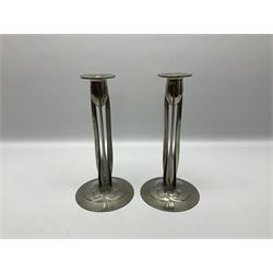 Archibald Knox (1864-1933) for Liberty & Co, pair of Tudric pewter candlesticks, the bud shaped sockets raised upon three angular fin supports and a slightly domed circular base with cast stylised foliate decoration, each stamped beneath Tudric 0223, H30cm