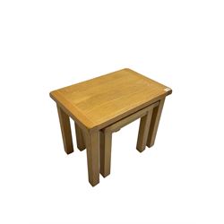 Light oak nest of two tables, rectangular top raised on square supports