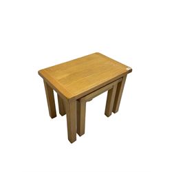Light oak nest of two tables, rectangular top raised on square supports