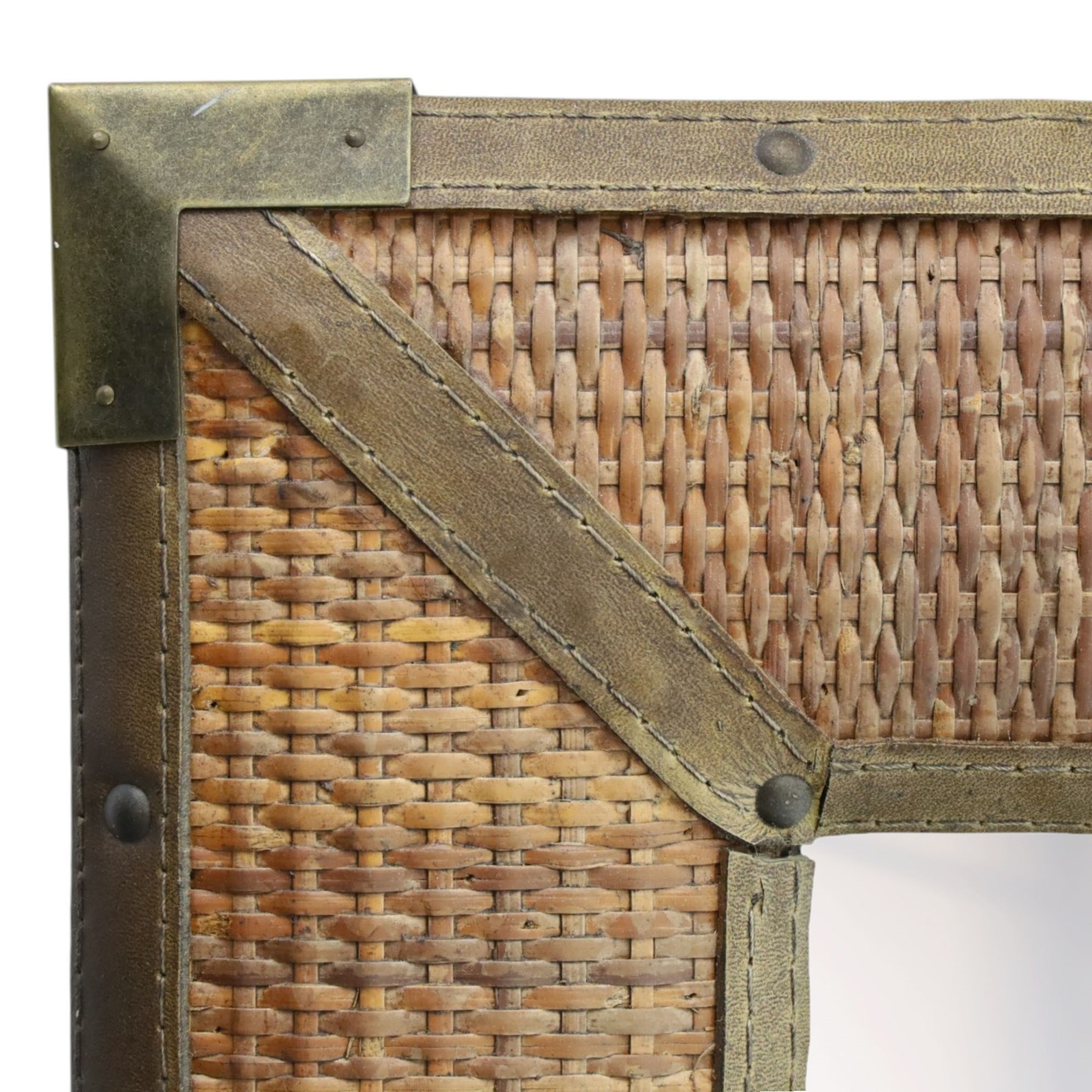 Rustic wall mirror with brass, leather and rattan frame, enclosing a bevelled plate