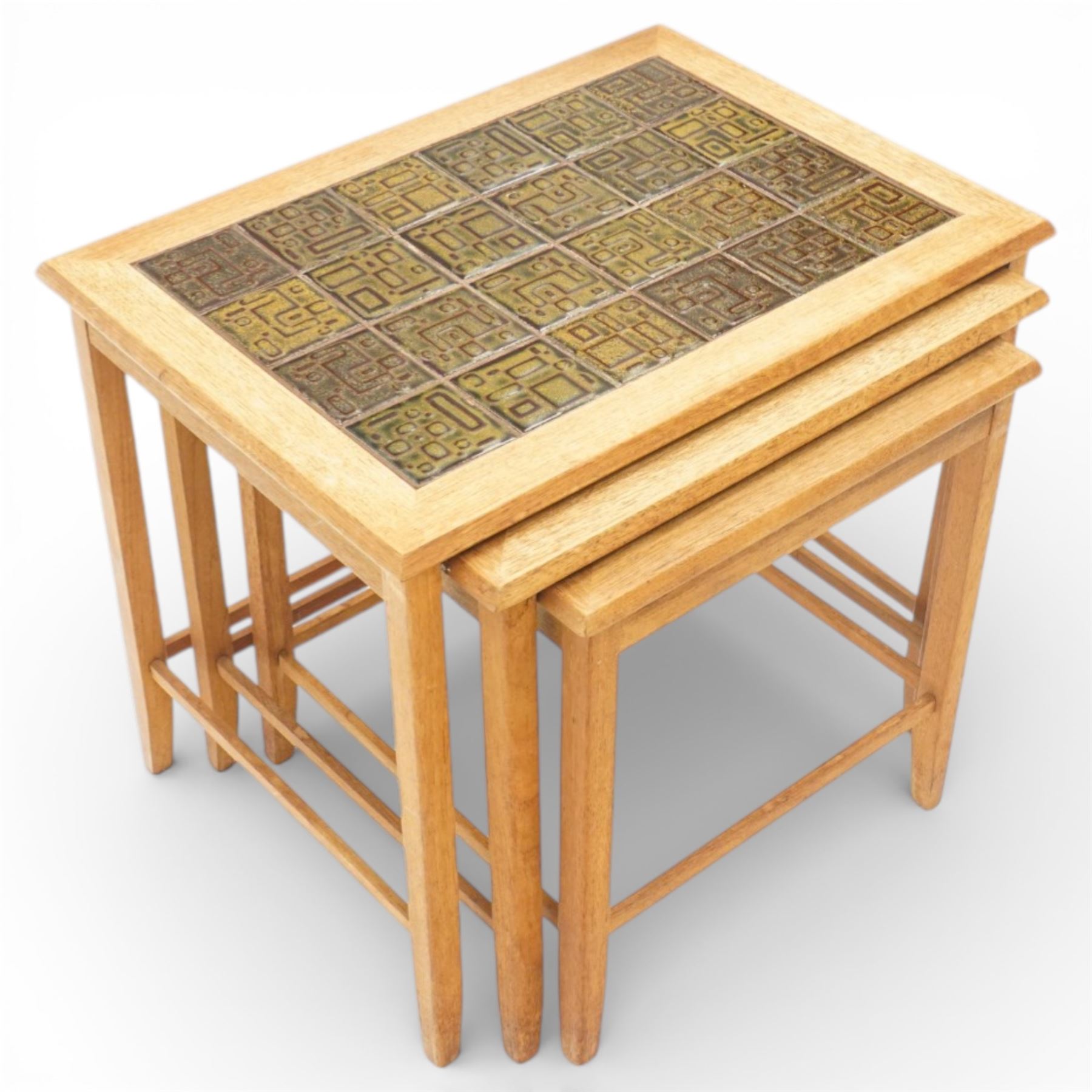 Mid 20th century Danish teak nest of three tables, rectangular tops inset with green geometric ceramic tiles within moulded frames, on square tapering supports united by stretchers